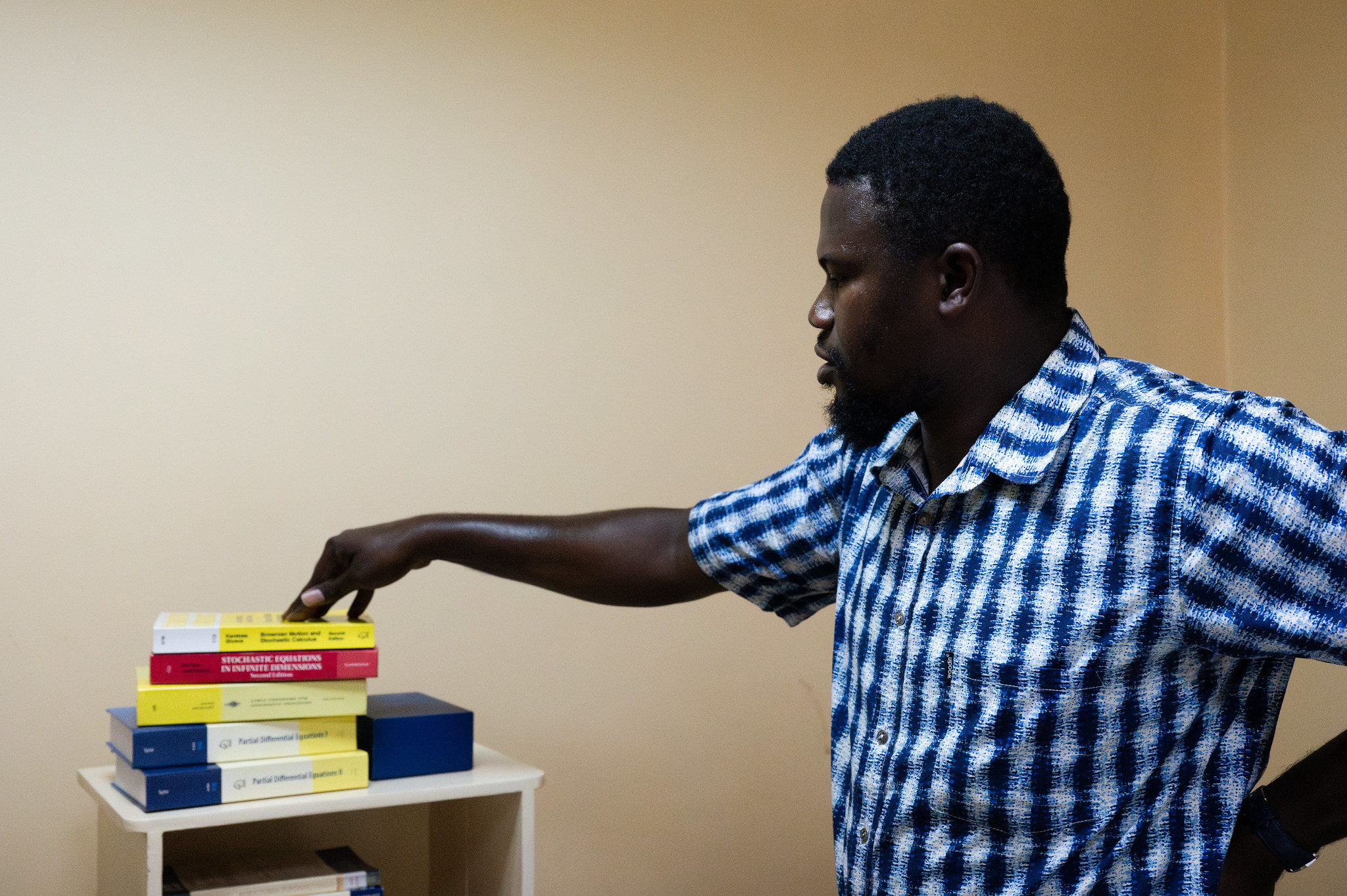 Moustapha Dieye, Lecturer at the Ecole Polytechnique de Thiès, Senegal, and the books he purchased thanks to a TWAS Research Grant (Photo: G.Ortolani/TWAS).