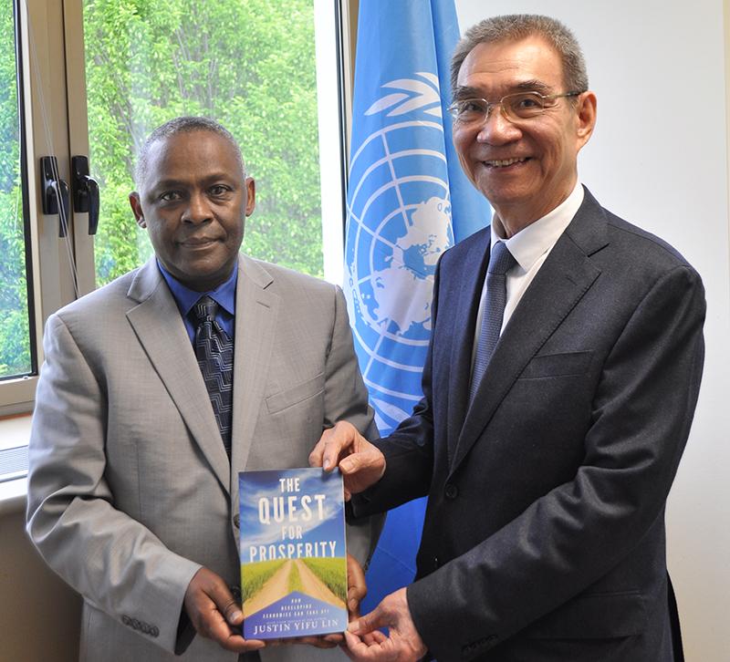 TWAS Executive Director Romain Murenzi, left, stands with TWAS Fellow Justin Yifu Lin during Lin’s visit to TWAS headquarters in Trieste, Italy, on 8 May 2023. They are holding a copy of Lin’s book, ‘The Quest for Prosperity: How Developing Economies Can Take Off’. [Photo: E. Vuck/TWAS]