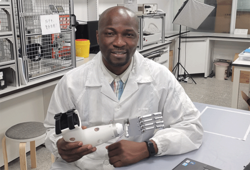 TWAS PhD Fellowship recipient Oluwarotimi Samuel shows a prosthesis built in his lab at the Shenzhen Institute of Advanced Technology in China. [Photo: SIAT-CAS]